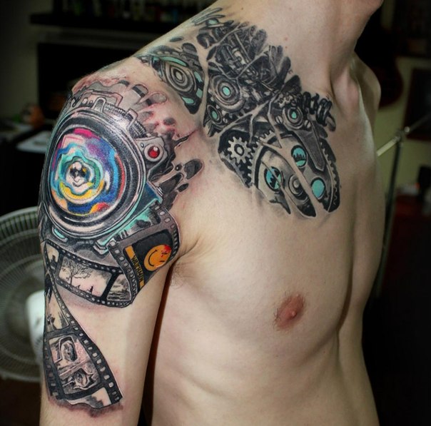 Colored tattoo in the style of biomechanics on the shoulder for men