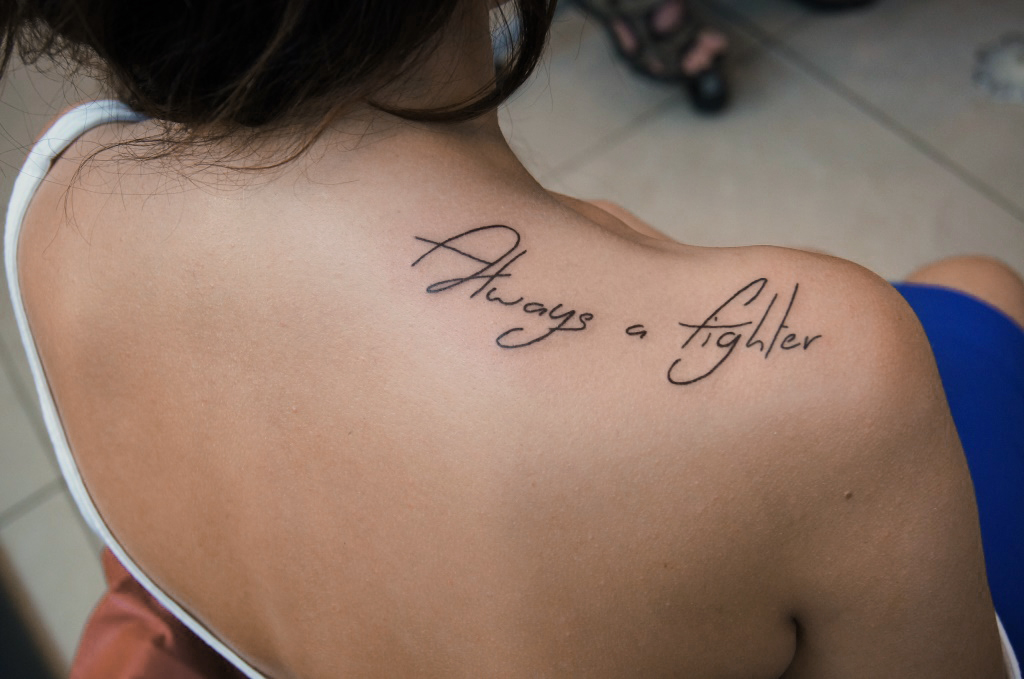 Calligraphy tattoo on the shoulder for women