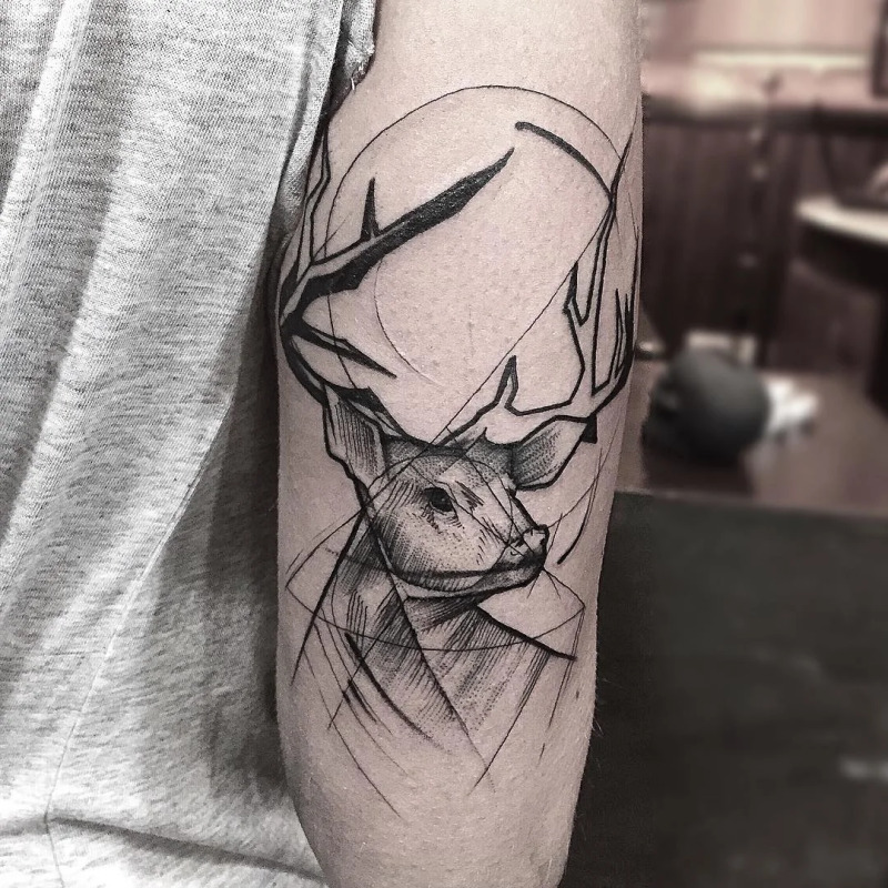 Deer tattoo in graphic style on the shoulder for women