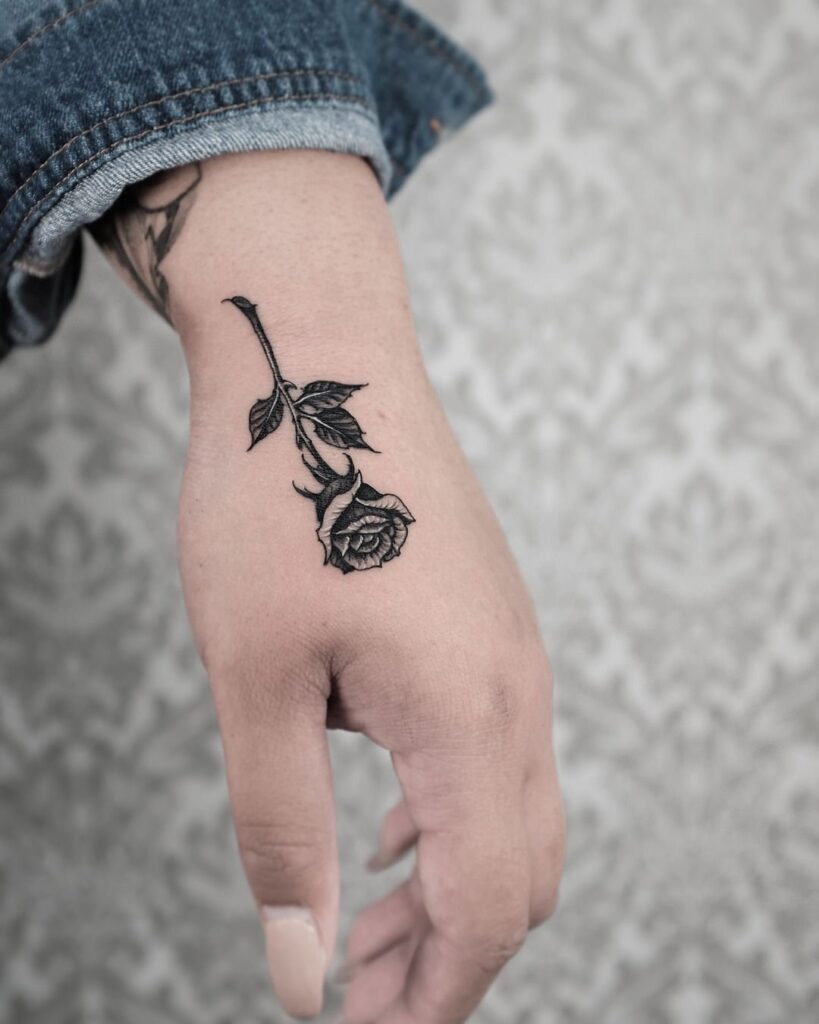 Rose tattoo on the hand for women