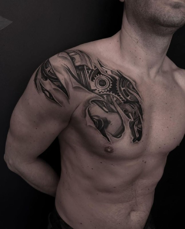 Large biomechanics-style tattoo on the chest for men