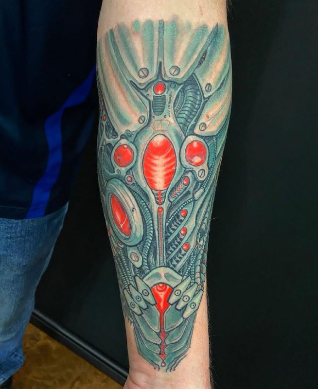 Color biomechanics style tattoo on the forearm for men