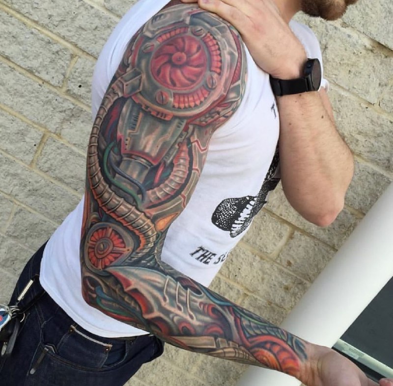 Biomechanics style tattoo on the arm for men