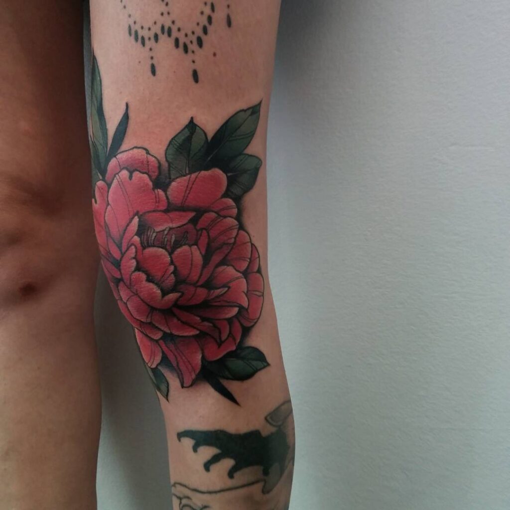 Large peony tattoo on the knee for women