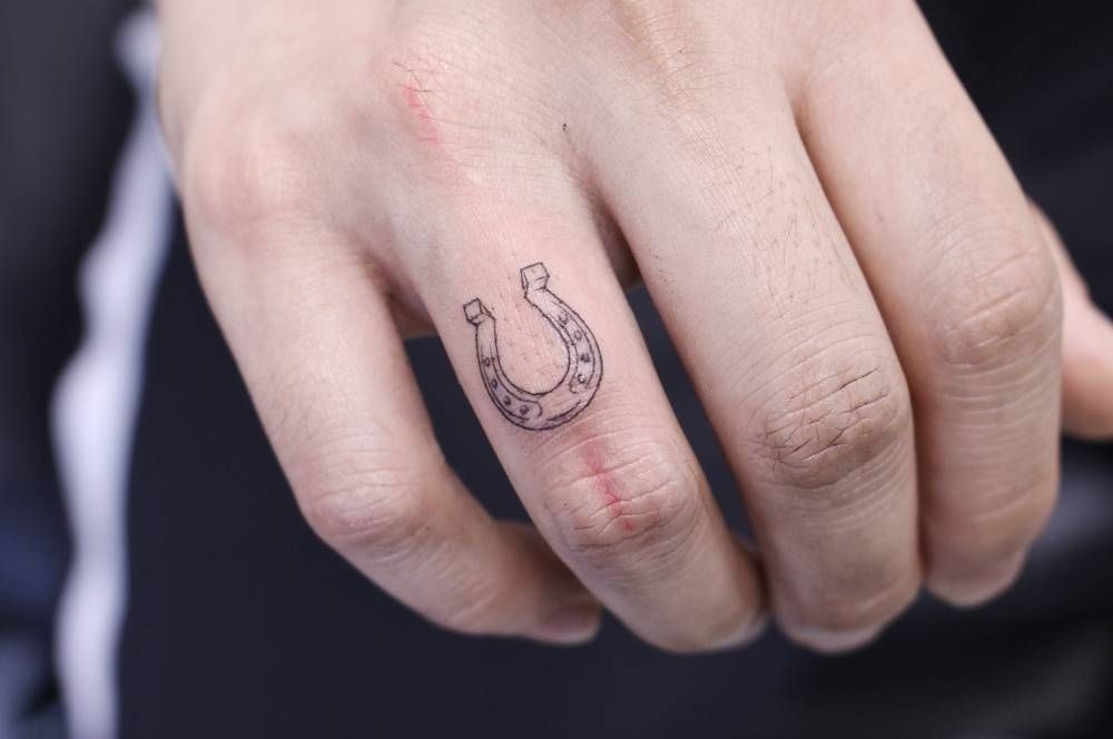 Horseshoe tattoo on the finger for men