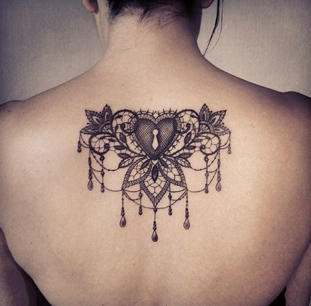 Baroque tattoo on the back for women