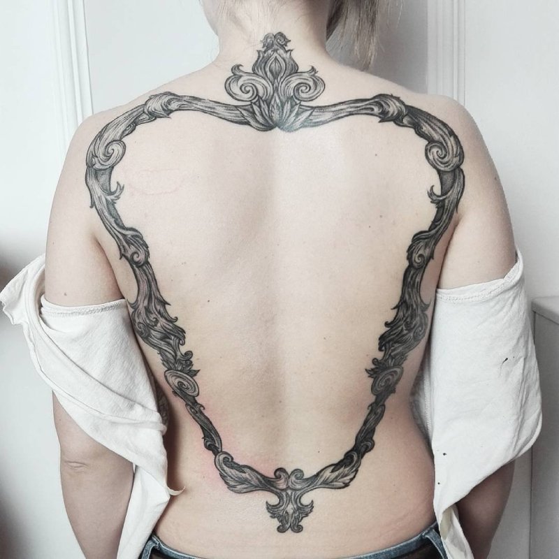 Large baroque tattoo on the back for women