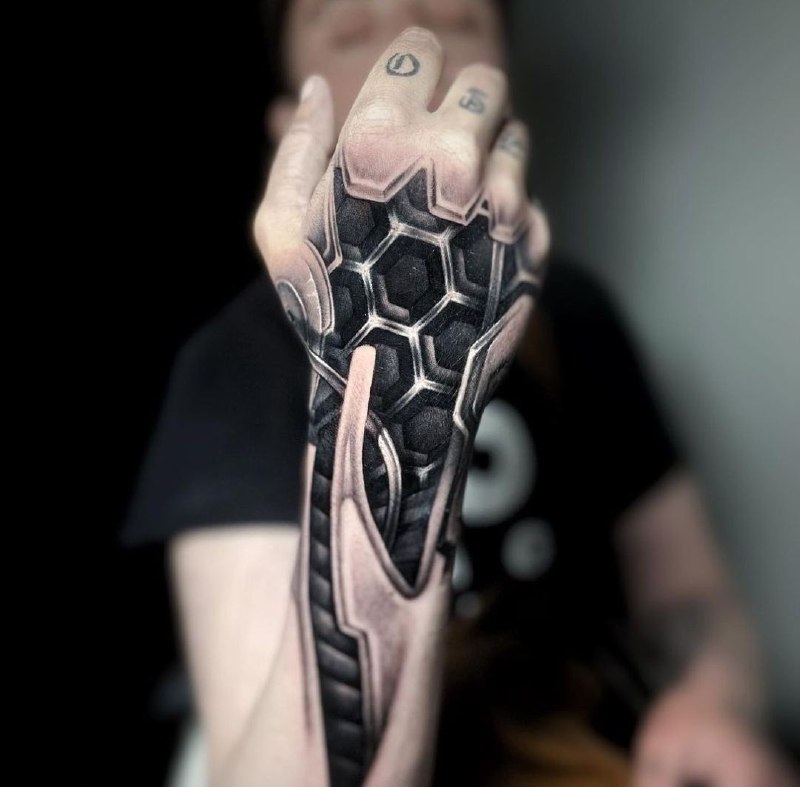 Biomechanics style tattoo on the arm for men