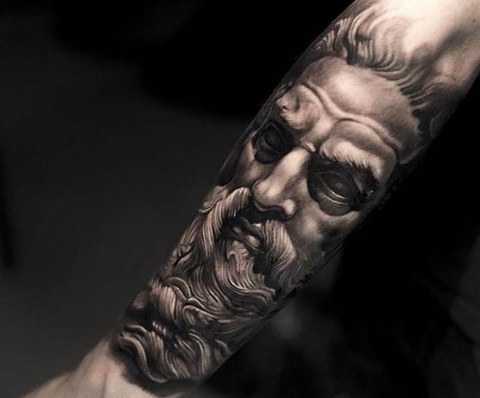 Large greek-style tattoo on the forearm for men