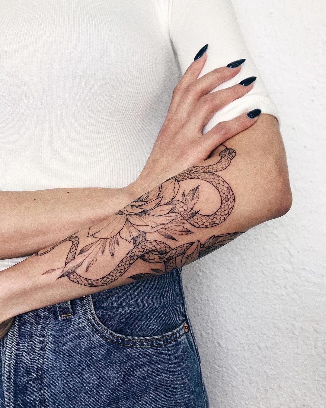 Snake and flower tattoo on the arm for women