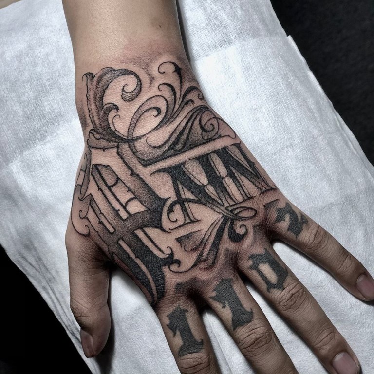 Tattoo with inscription on the hand for men