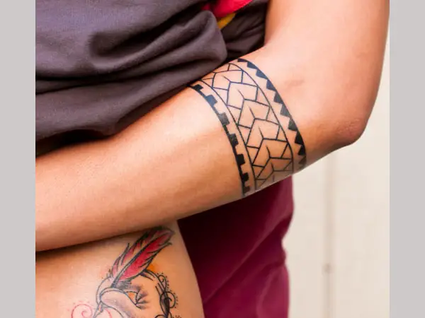 Tribal style tattoo on forearm for women