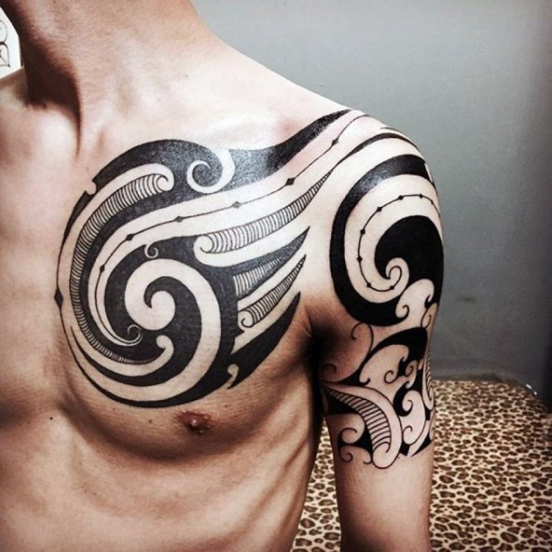 Tribal style tattoo on chest for men