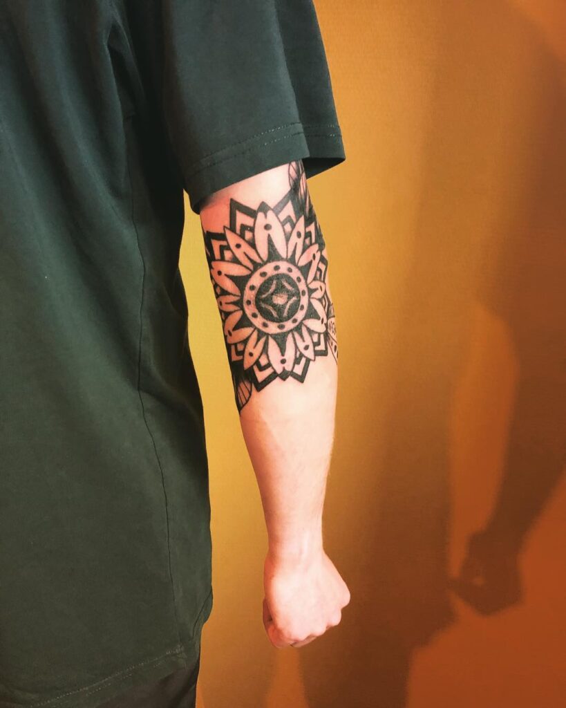 Ornamental style tattoo on the arm for men