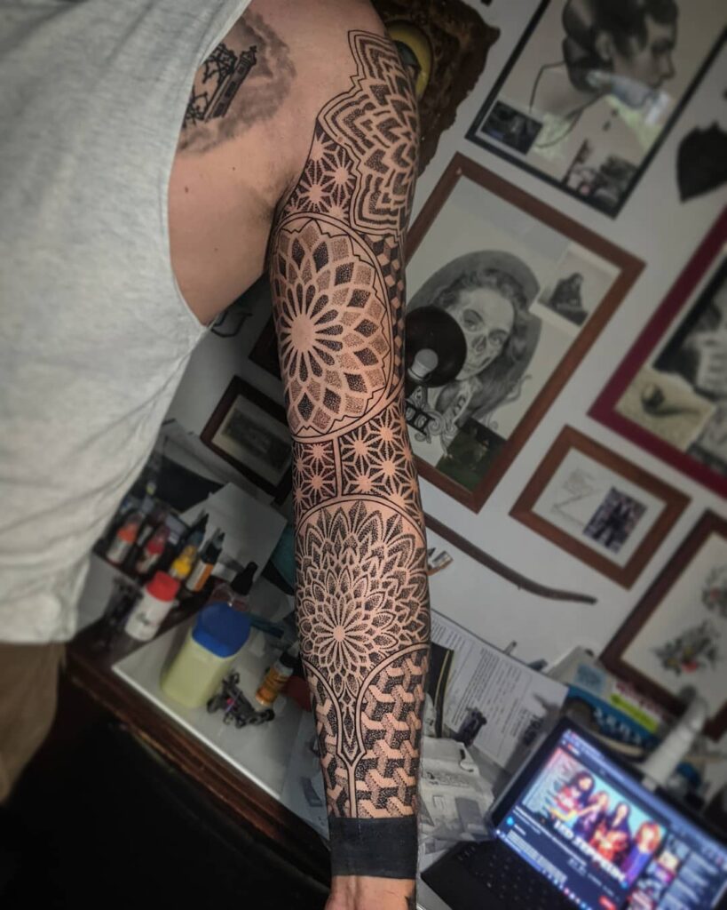 Ornamental style tattoo on the arm for men