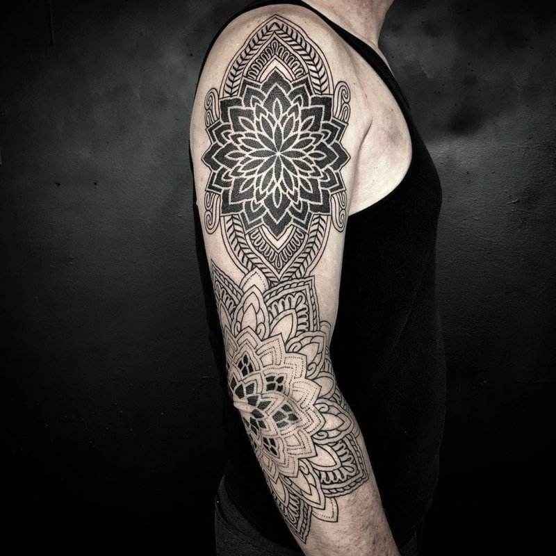 Ornamental style tattoo on the arm for men