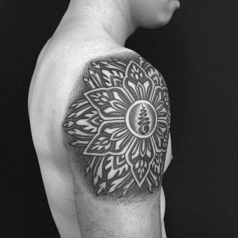 Ornamental style tattoo on the shoulder for men