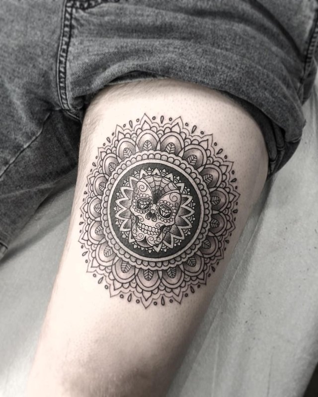 Ornamental style tattoo on the hip for men