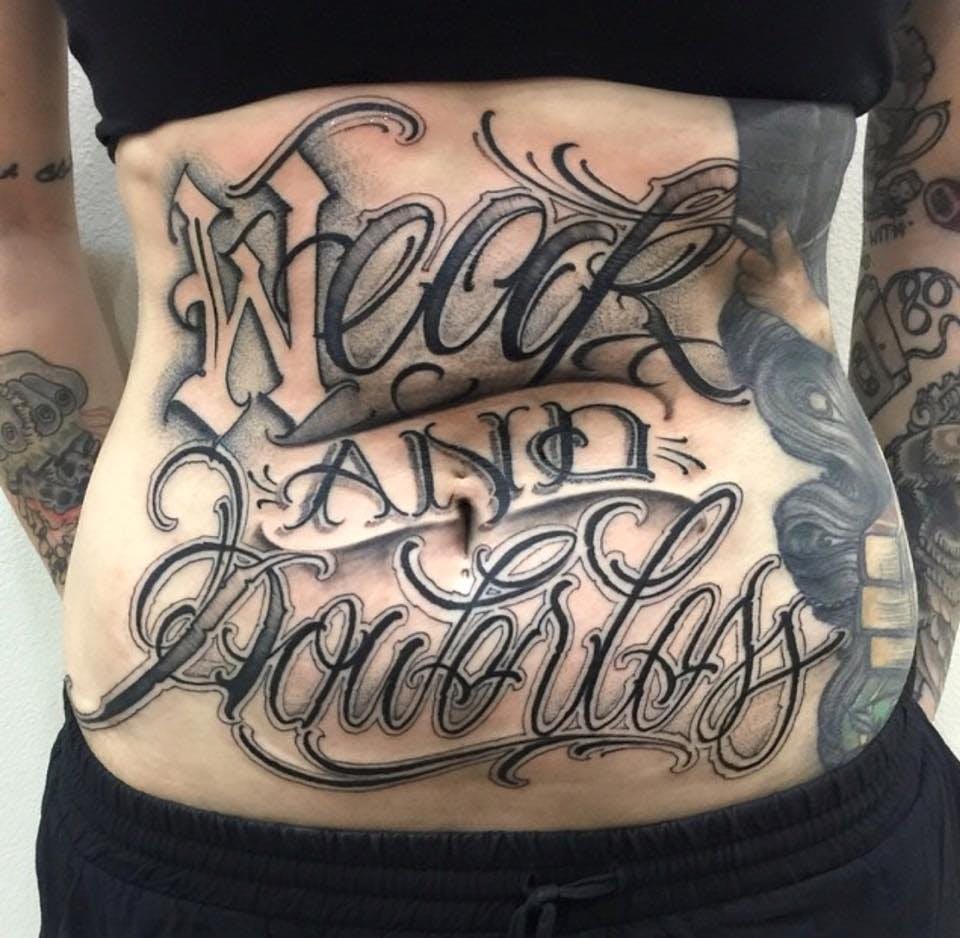 Lettering style tattoos on the stomach for women