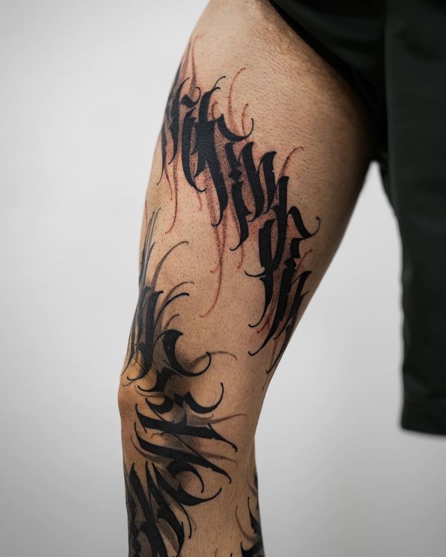 Lettering style tattoos on the knee for men