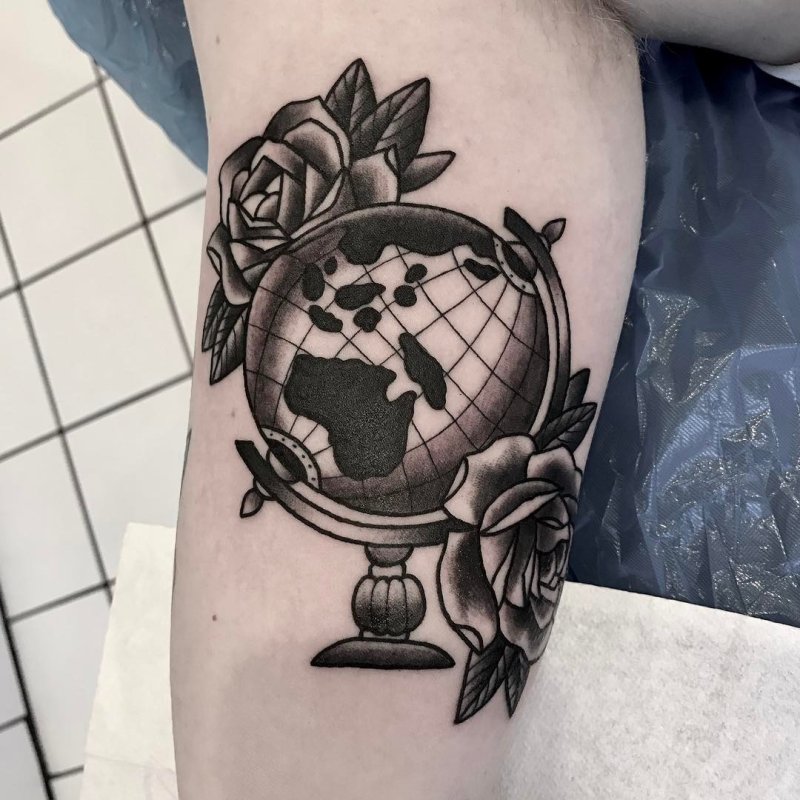 Globe tattoo on shoulder for men