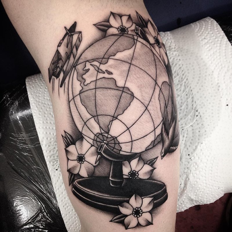 Large globe tattoo on the arm for men