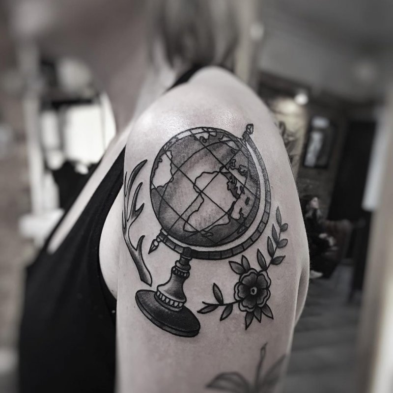 Globe tattoo on shoulder for women