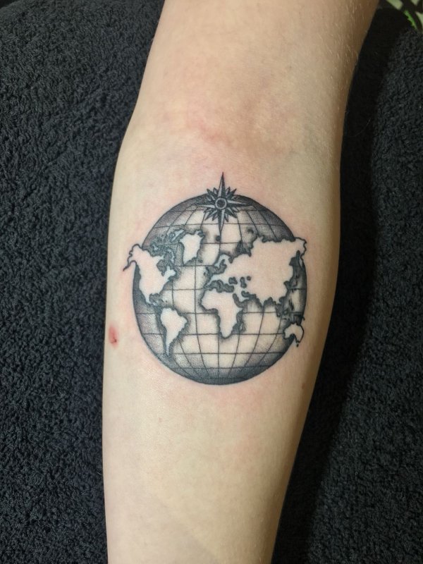 Globe tattoo on forearm for men