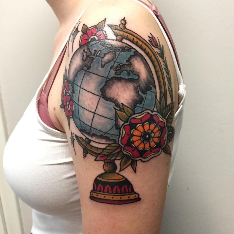 Large globe tattoo on the shoulder for women