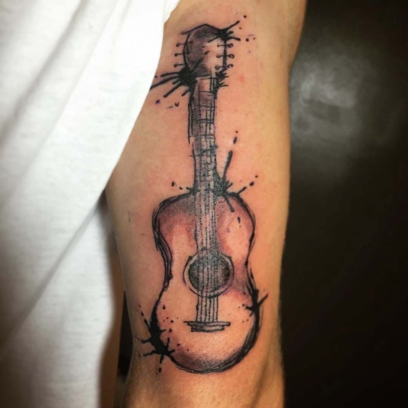 Guitar tattoo on the shoulder for men