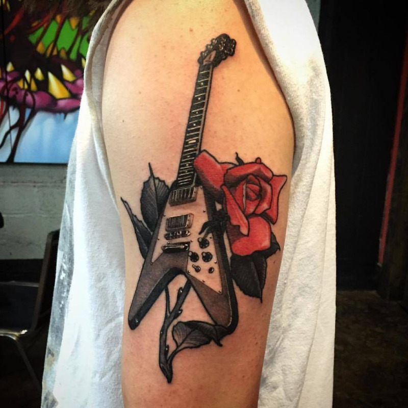 Guitar tattoo with a rose on the shoulder for men