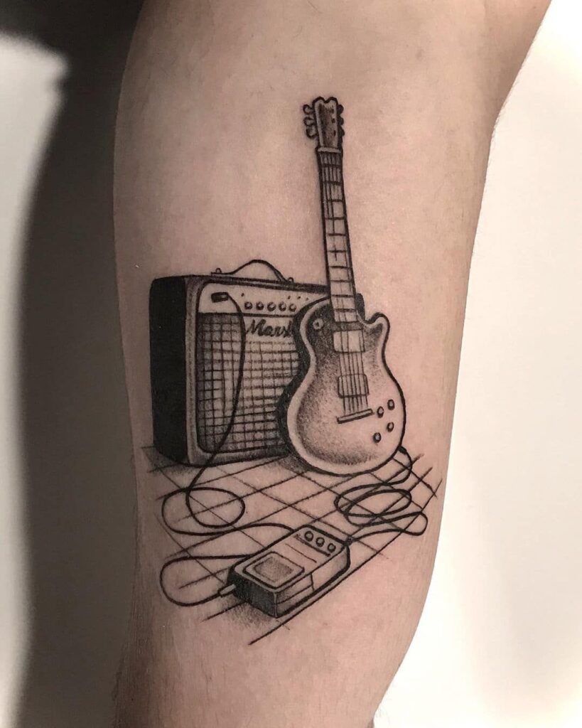 Guitar tattoo on thigh for men