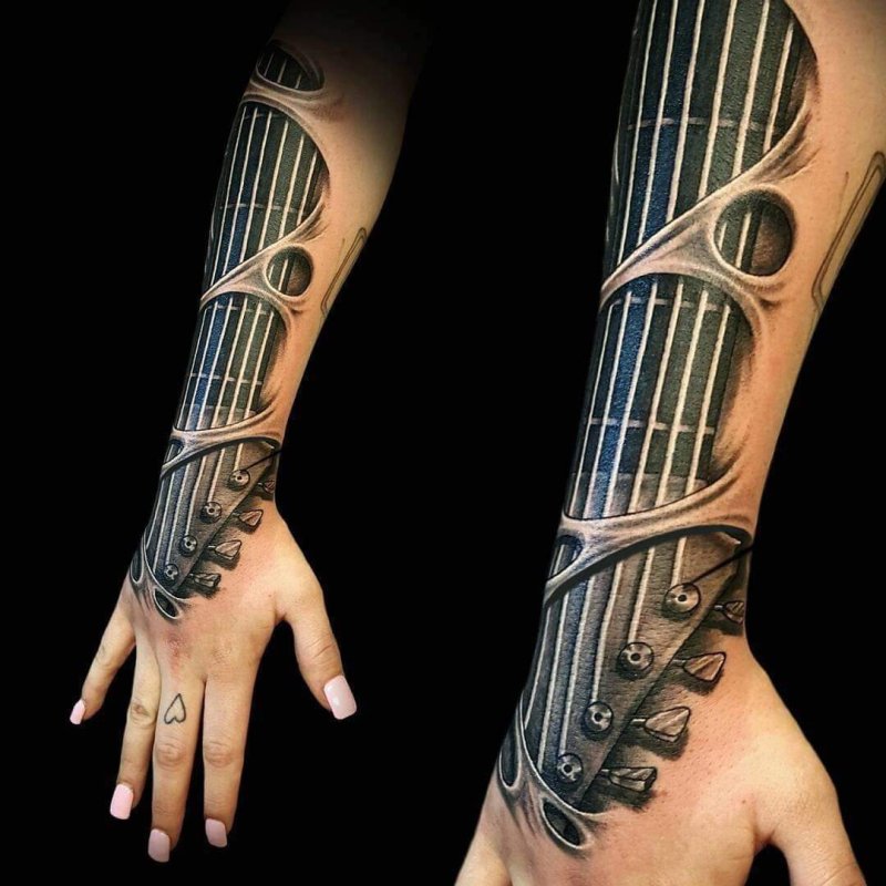 Guitar tattoo on the arm for women