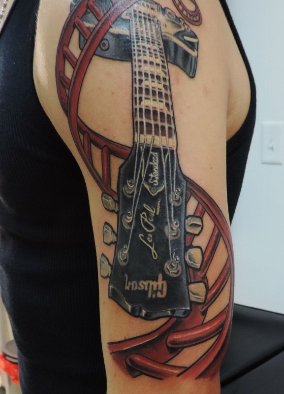 Colorful guitar tattoo on shoulder for men