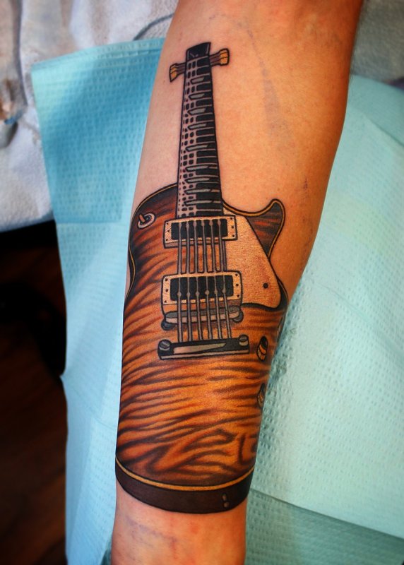 Guitar tattoo on forearm for men