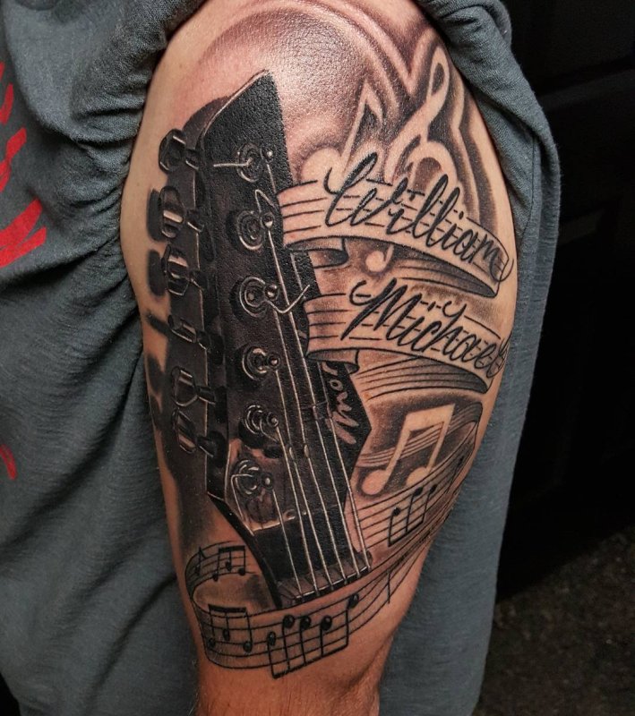 Guitar tattoo on the shoulder for men