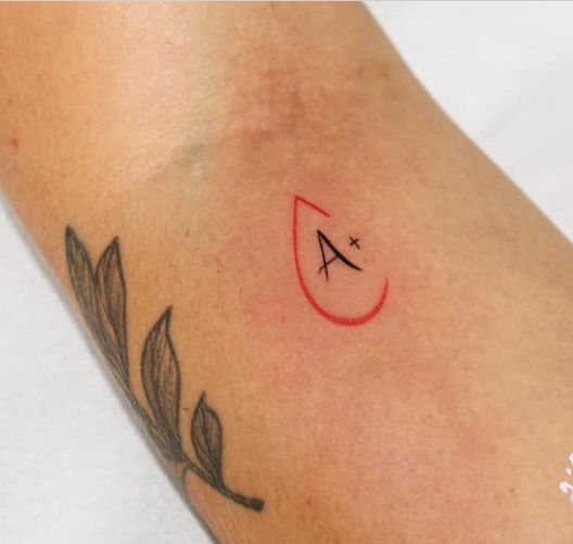 Blood type tattoo on forearm for women