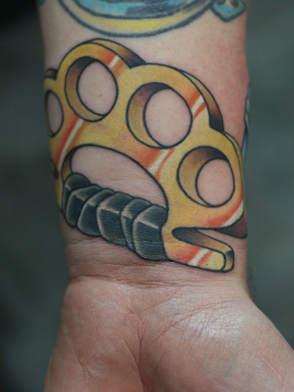 Colorful knuckle tattoo on wrist for men