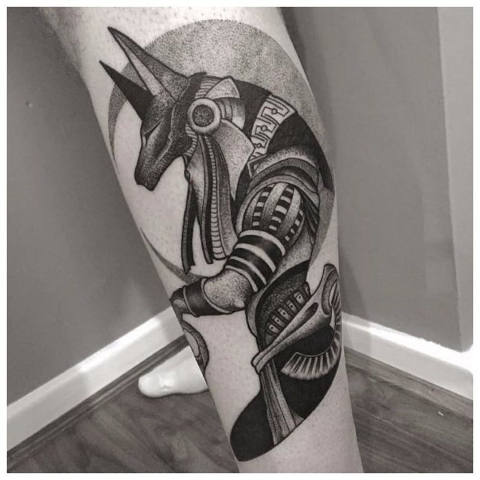 Anubis tattoo on the shin for men