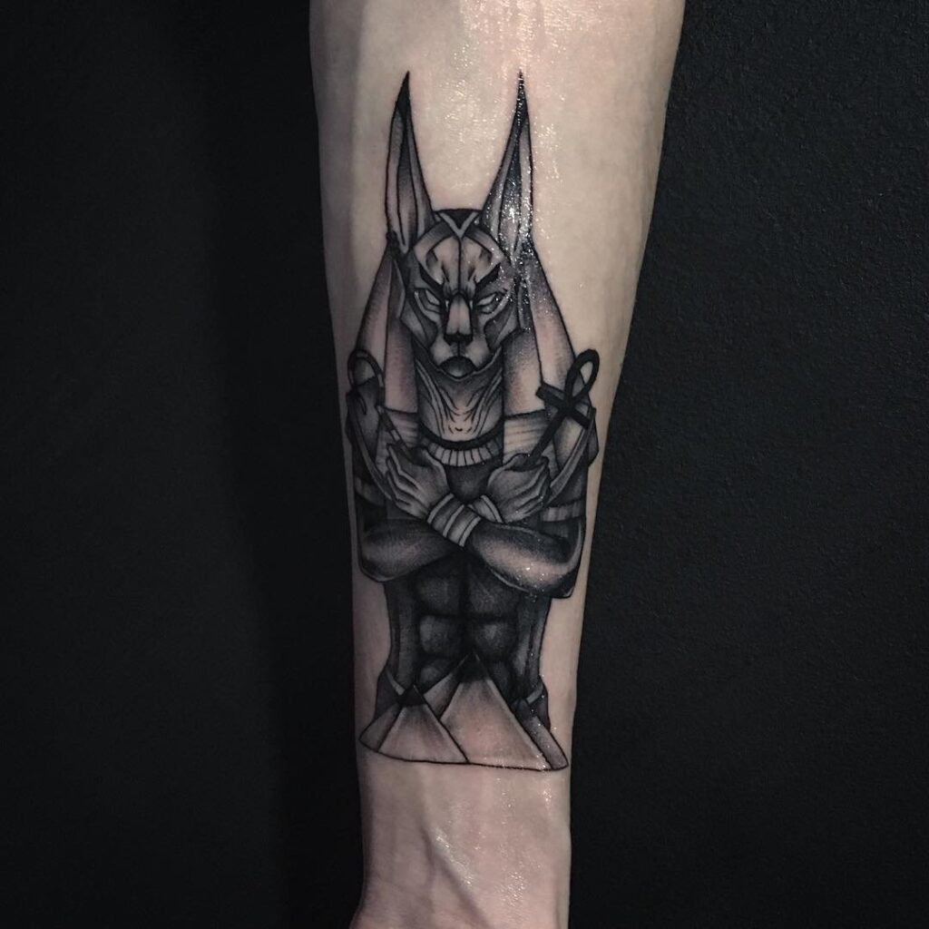 Anubis tattoo on the arm for men