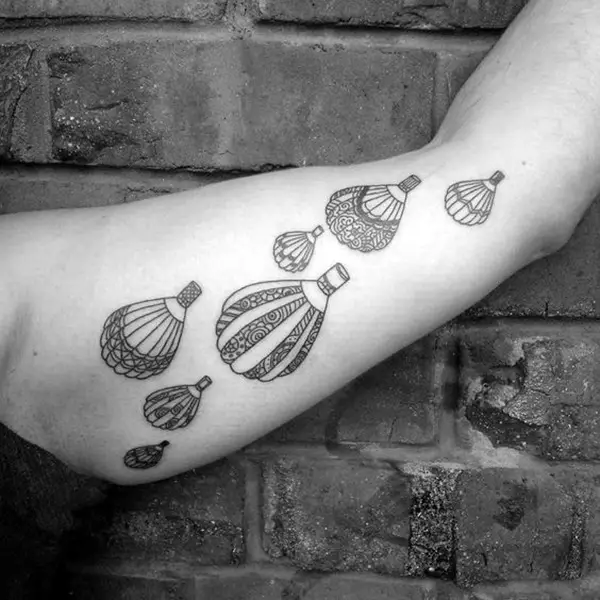 Seven balloons tattoo on the arm for men