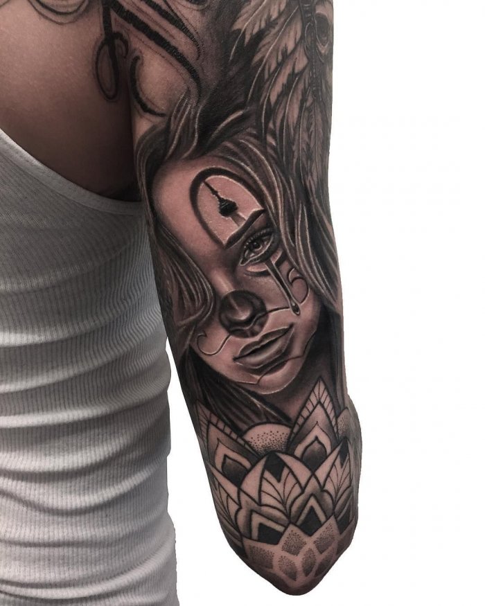 Chicano style tattoo on the shoulder for women