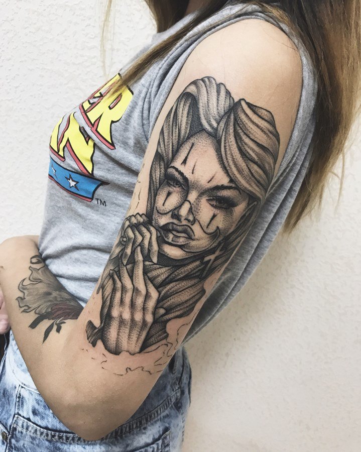 Chicano style tattoo on the shoulder for women