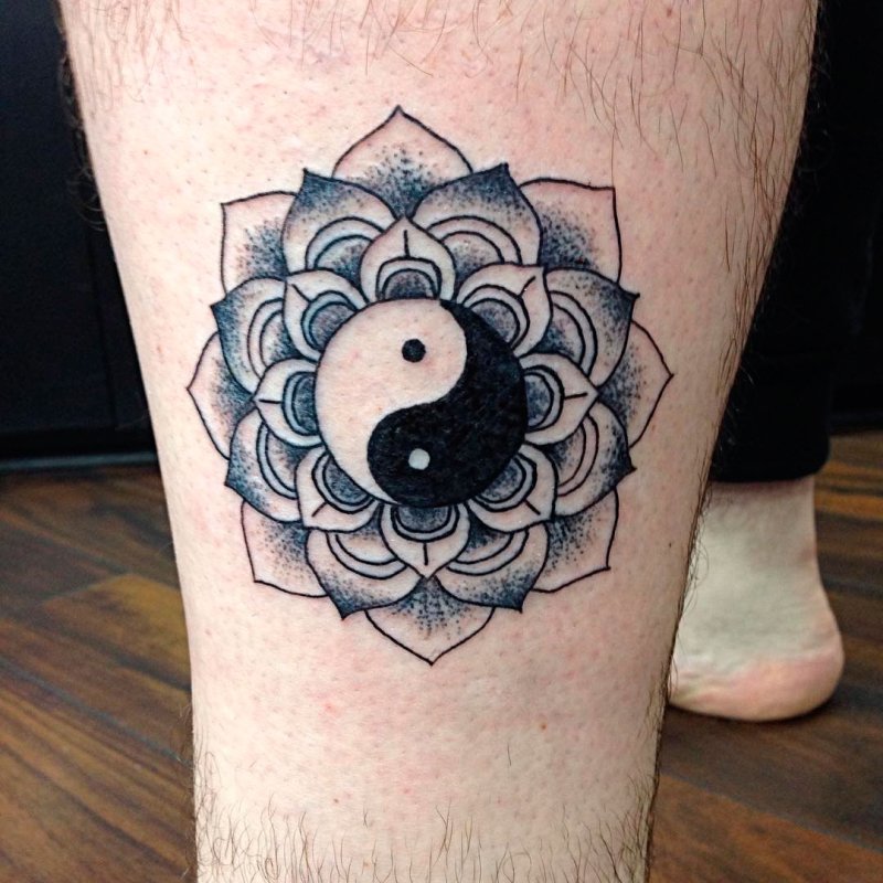 Yin-yang tattoo on leg for men