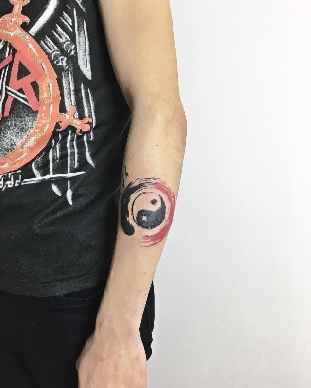 Yin-yang tattoo on forearm for men