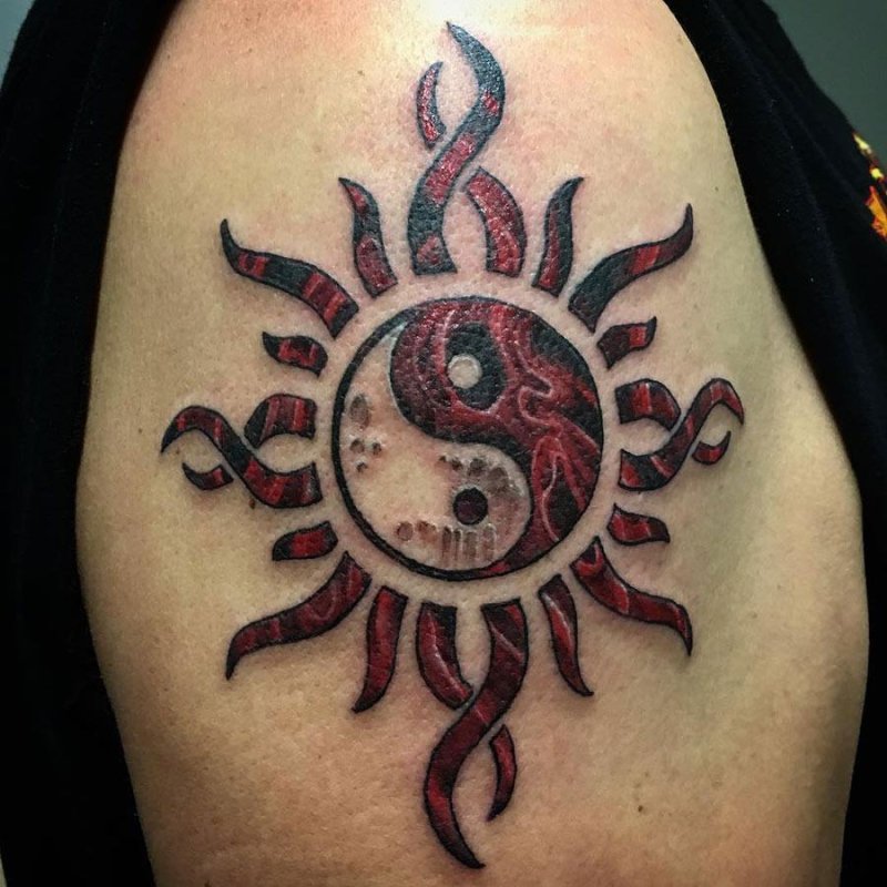 Colorful yin-yang tattoo on the shoulder for men