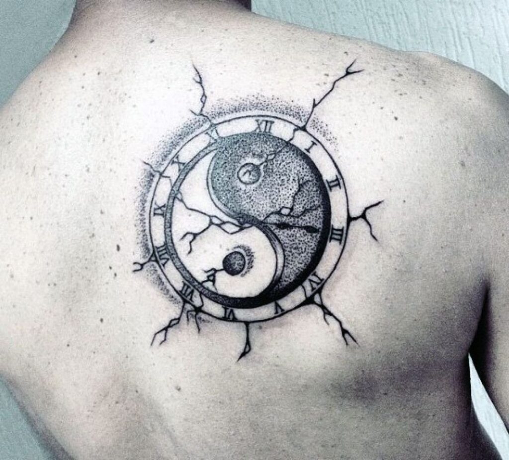 Yin-yang tattoo on the shoulder blade for men