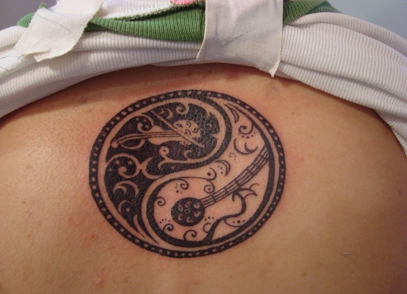 Yin-yang tattoo on the abdomen for women