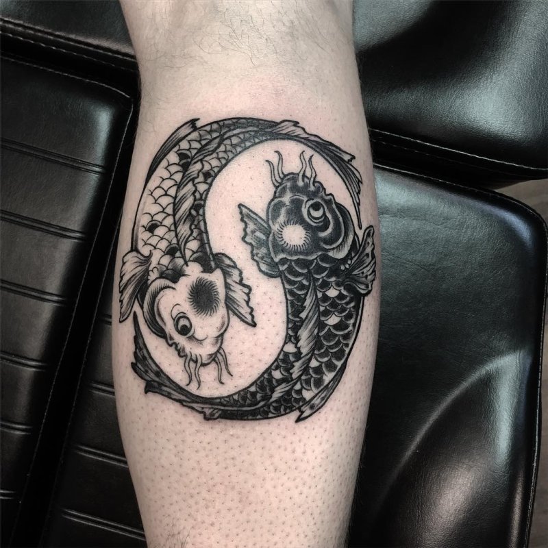 Yin-yang tattoo on the calf for men