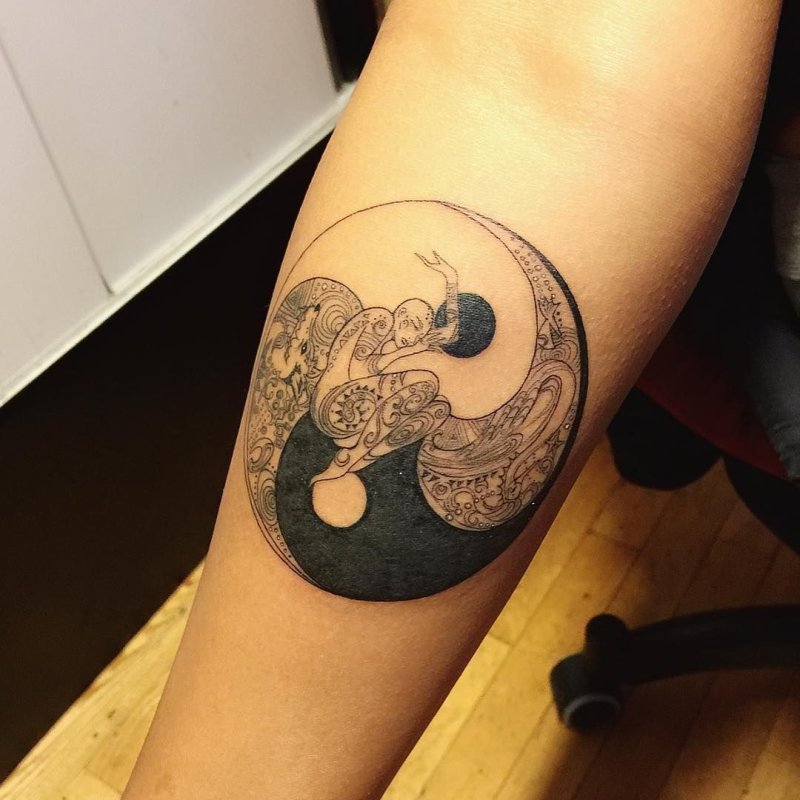 Yin-yang tattoo on forearm for men